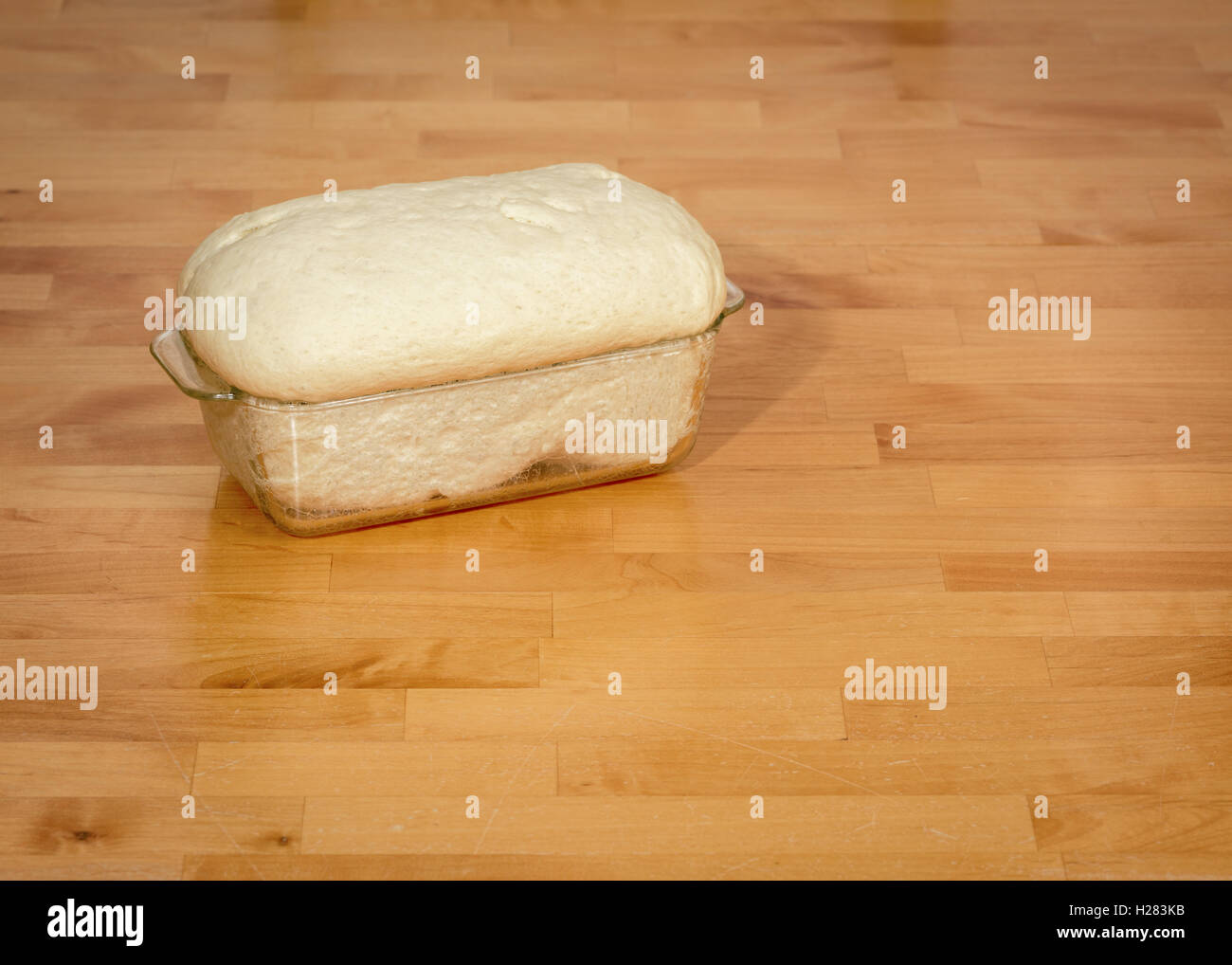 rising bread dough in a glass dish Stock Photo