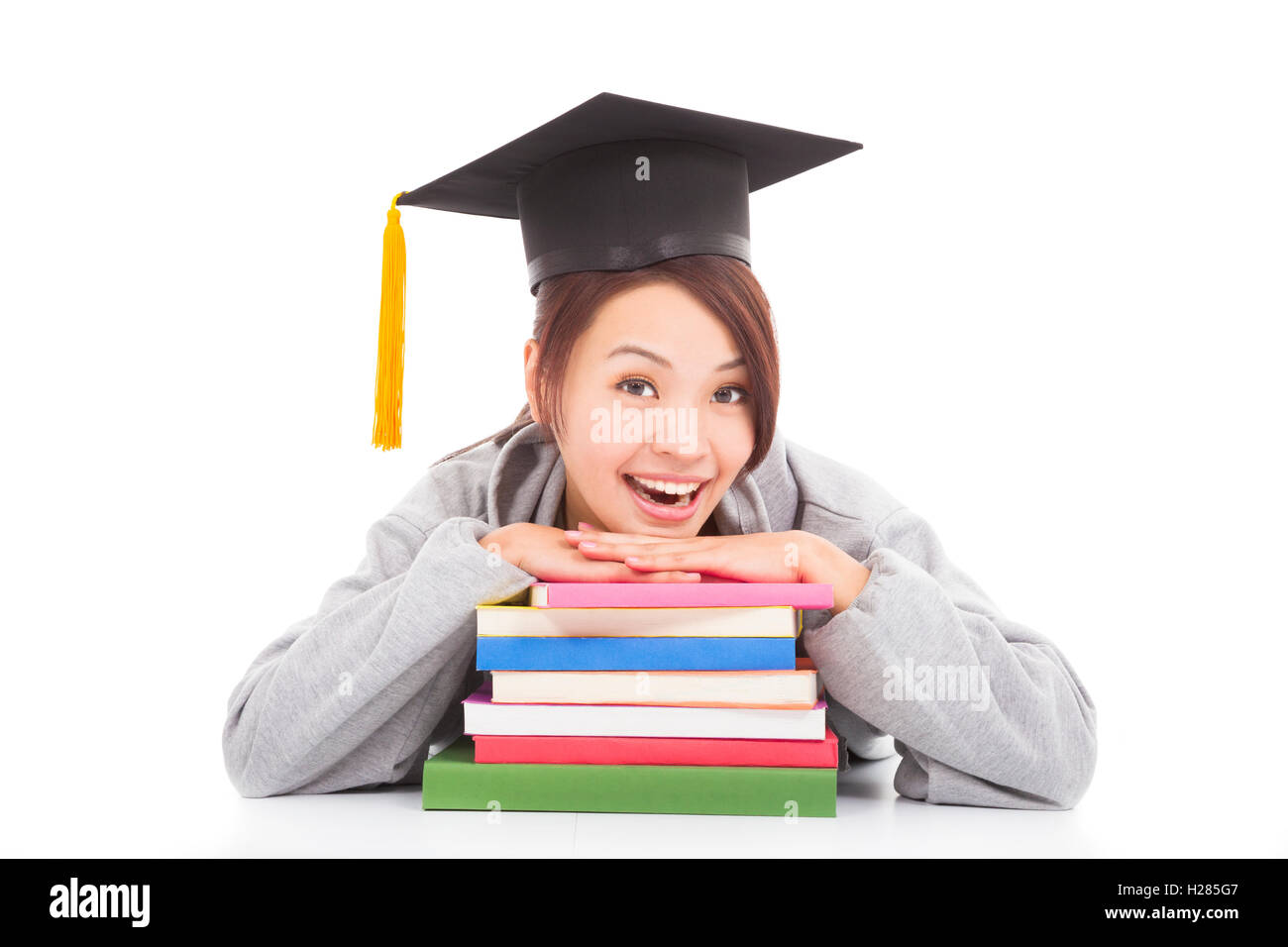 happy student leaning on stacked books Stock Photo - Alamy