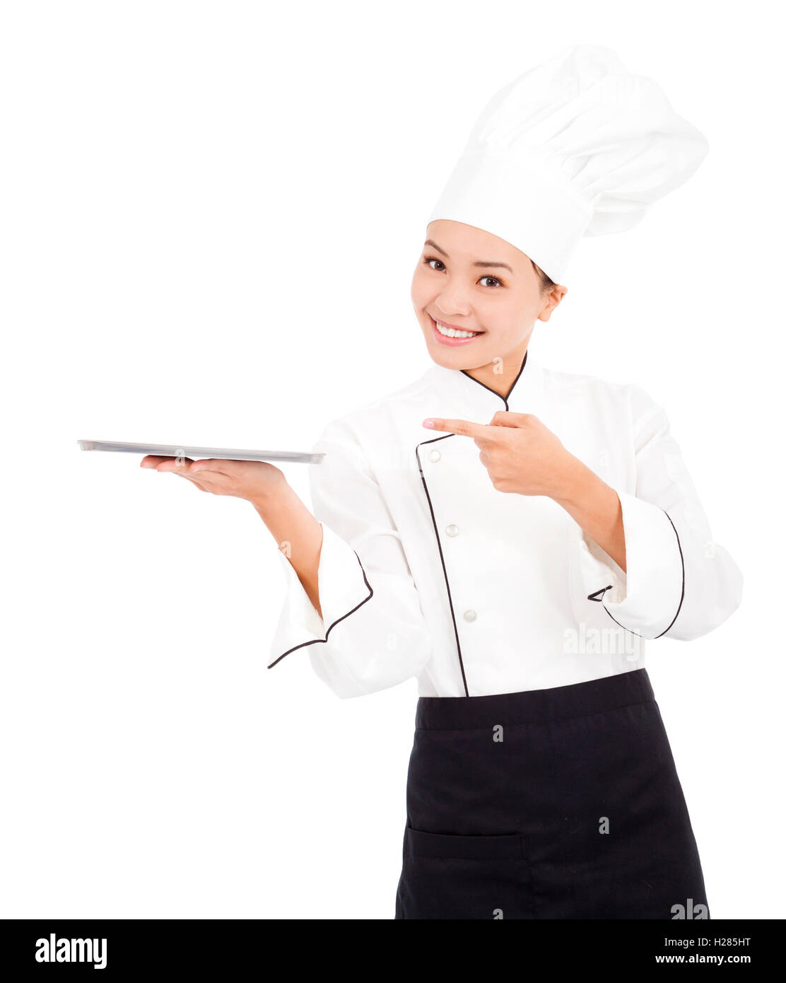 Pretty cook woman chef holding tray and looking Stock Photo - Alamy