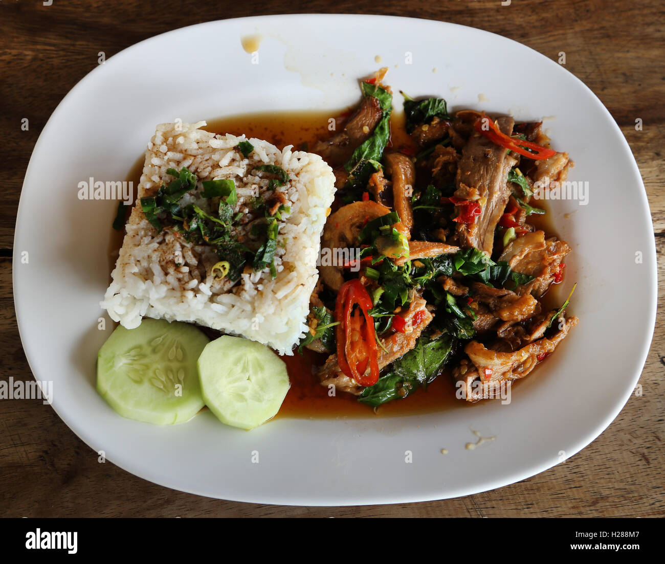 Fried pork with sweet basi and white jasmine sticky rice Stock Photo