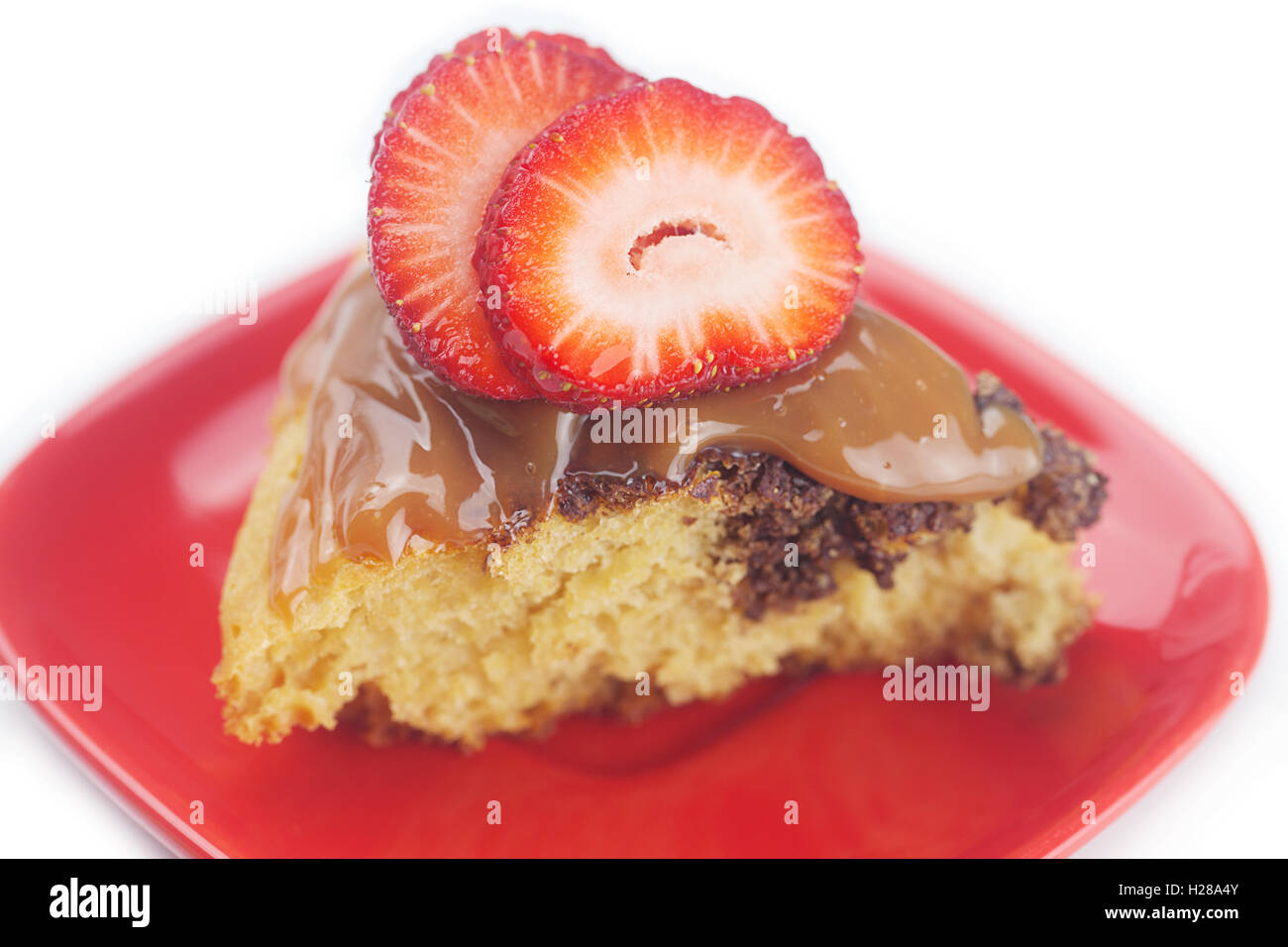 cake with condensed milk and strawberries isolated on white Stock Photo