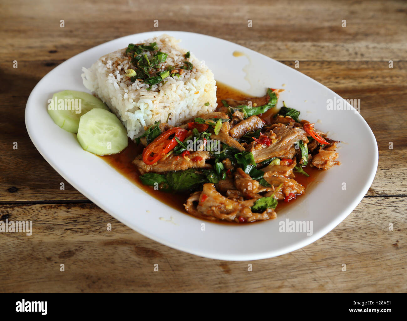 Fried pork with sweet basi and white jasmine sticky rice Stock Photo