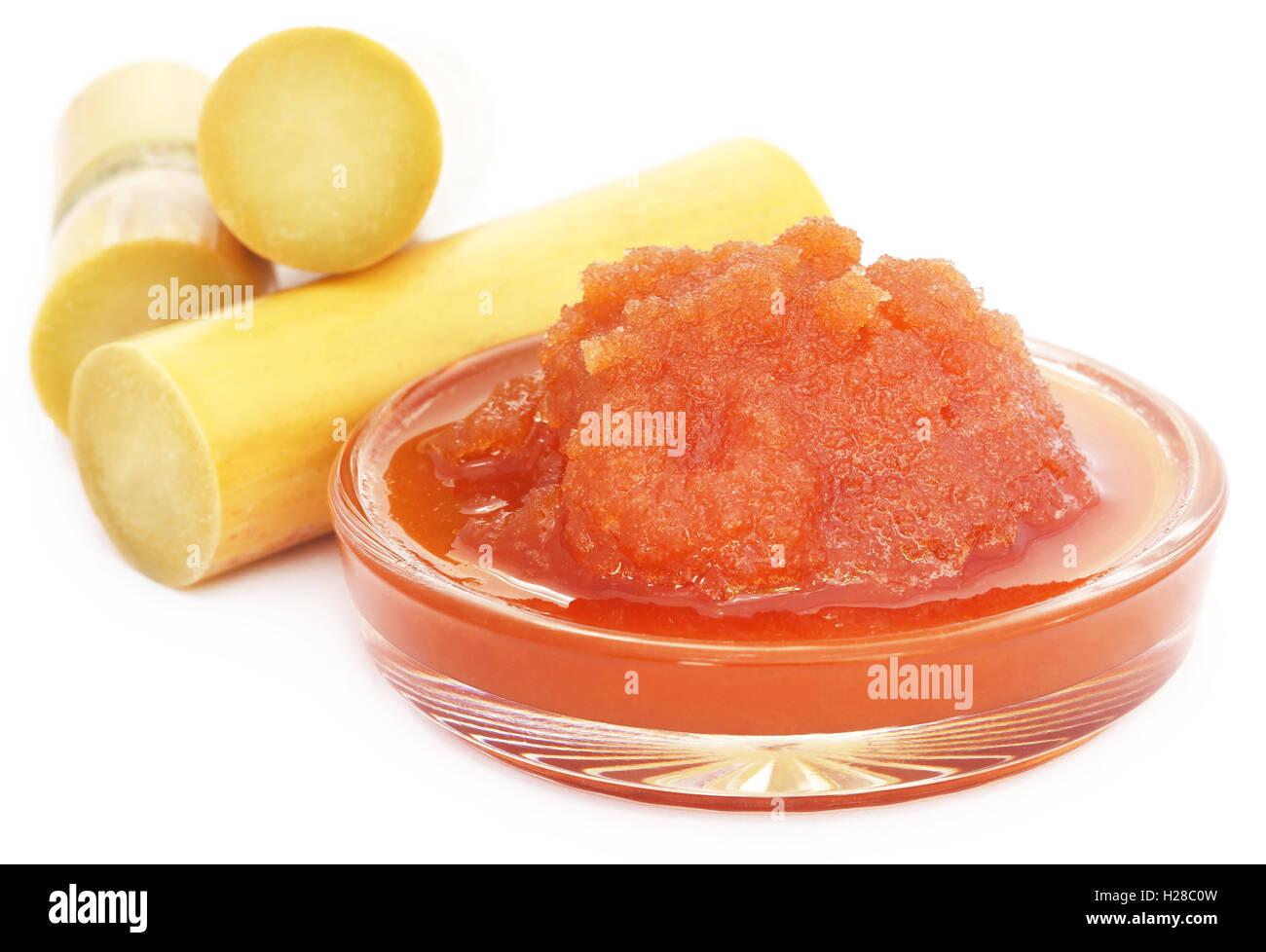 Molasses with sugarcane over white background Stock Photo