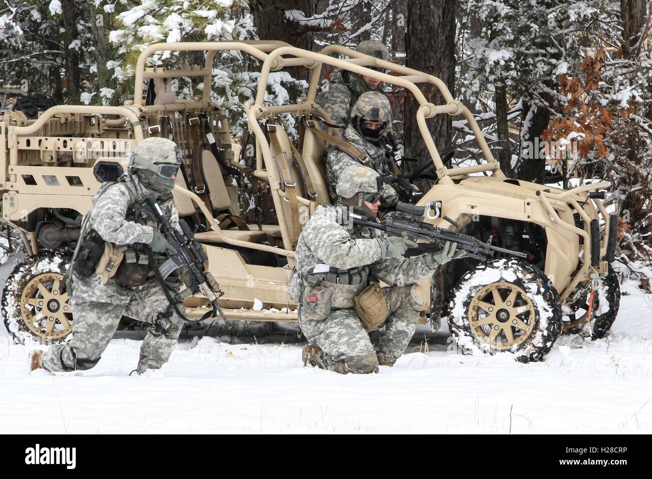 U.S. Army soldiers practice training with the new Light Tactical All Terrain Vehicle at Fort Pickett February 26, 2015 in Blackstone, Virginia. Stock Photo