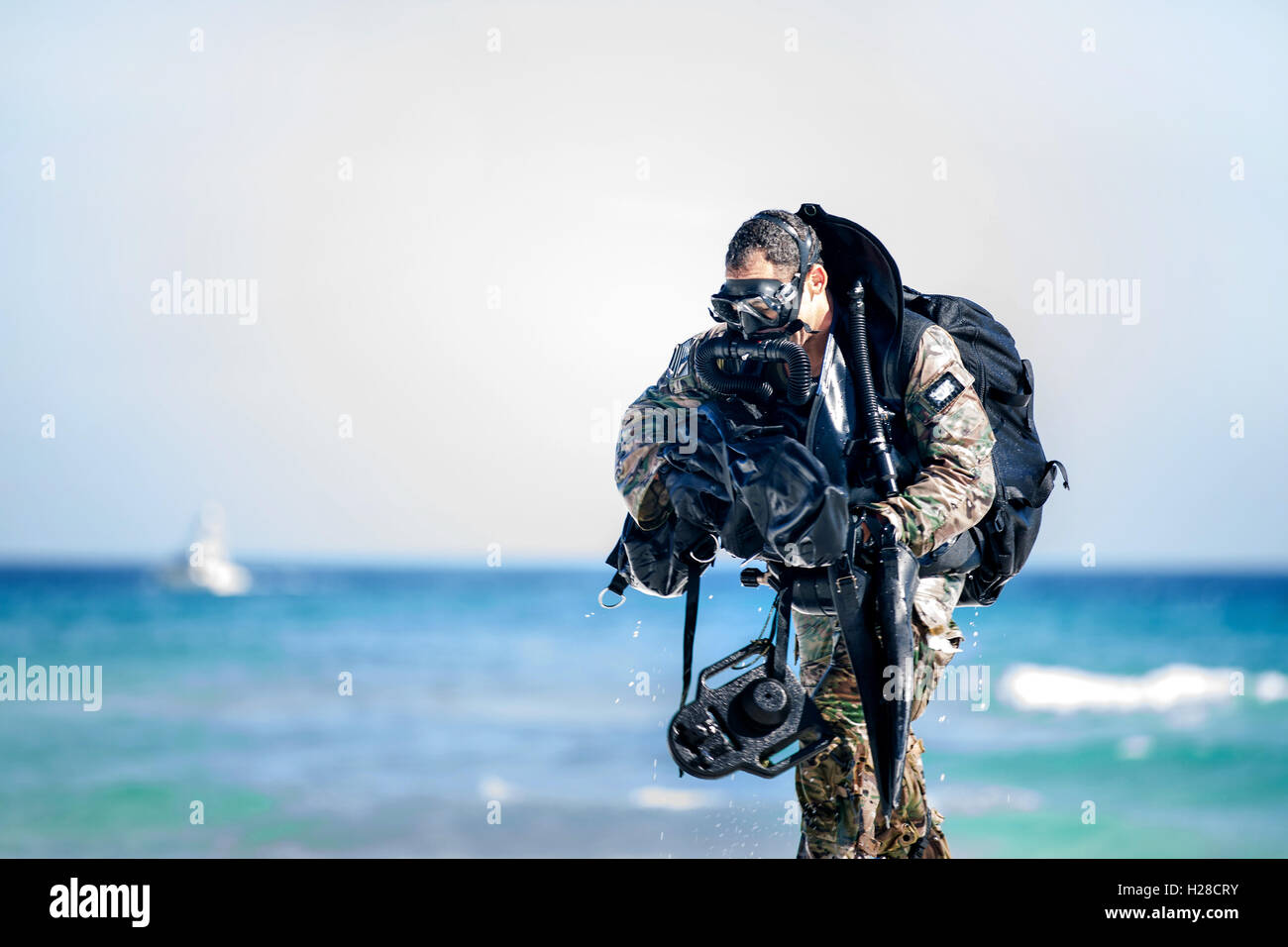 A U.S. Army Green Beret commando emerges from the Gulf of Mexico during underwater infiltration training April 2, 2015 in Okaloosa Island, Florida. Stock Photo