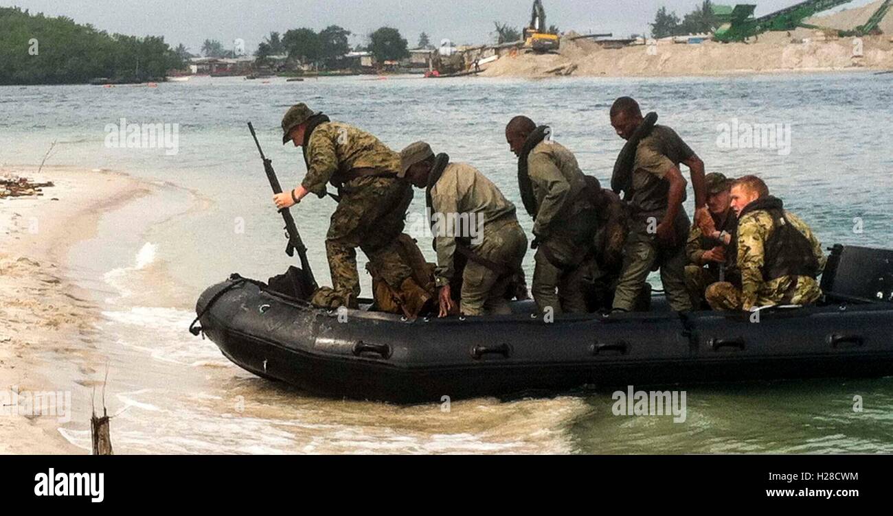 U.S., Gabonese, and British Marines land ashore on the beach at the Gabon Naval Base during an Africa Partnership Station joint training activity September 1, 2014 in Port Gentil, Gabon. Stock Photo