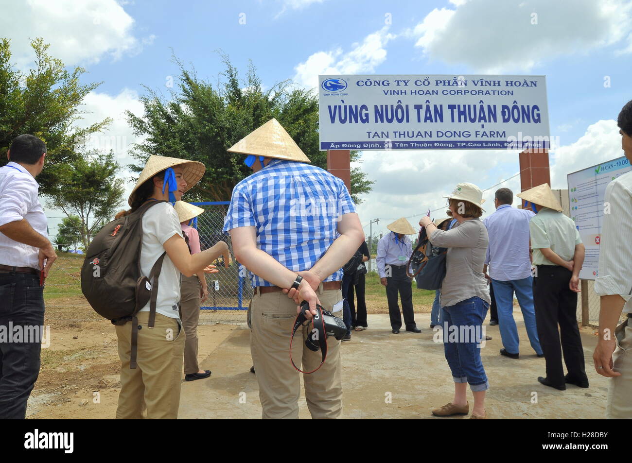 Dong Thap, Vietnam - March 1, 2013: International reporters and journalists are about to enter a pangasius catfish farm in the m Stock Photo