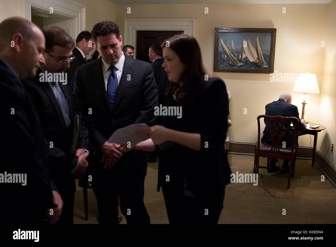 Israeli President Shimon Peres (right) sits at a table in the corner of the Oval Office hallway while staff discuss notes prior to meeting with U.S. President Barack Obama at the White House June 25, 2014 in Washington, DC. Stock Photo