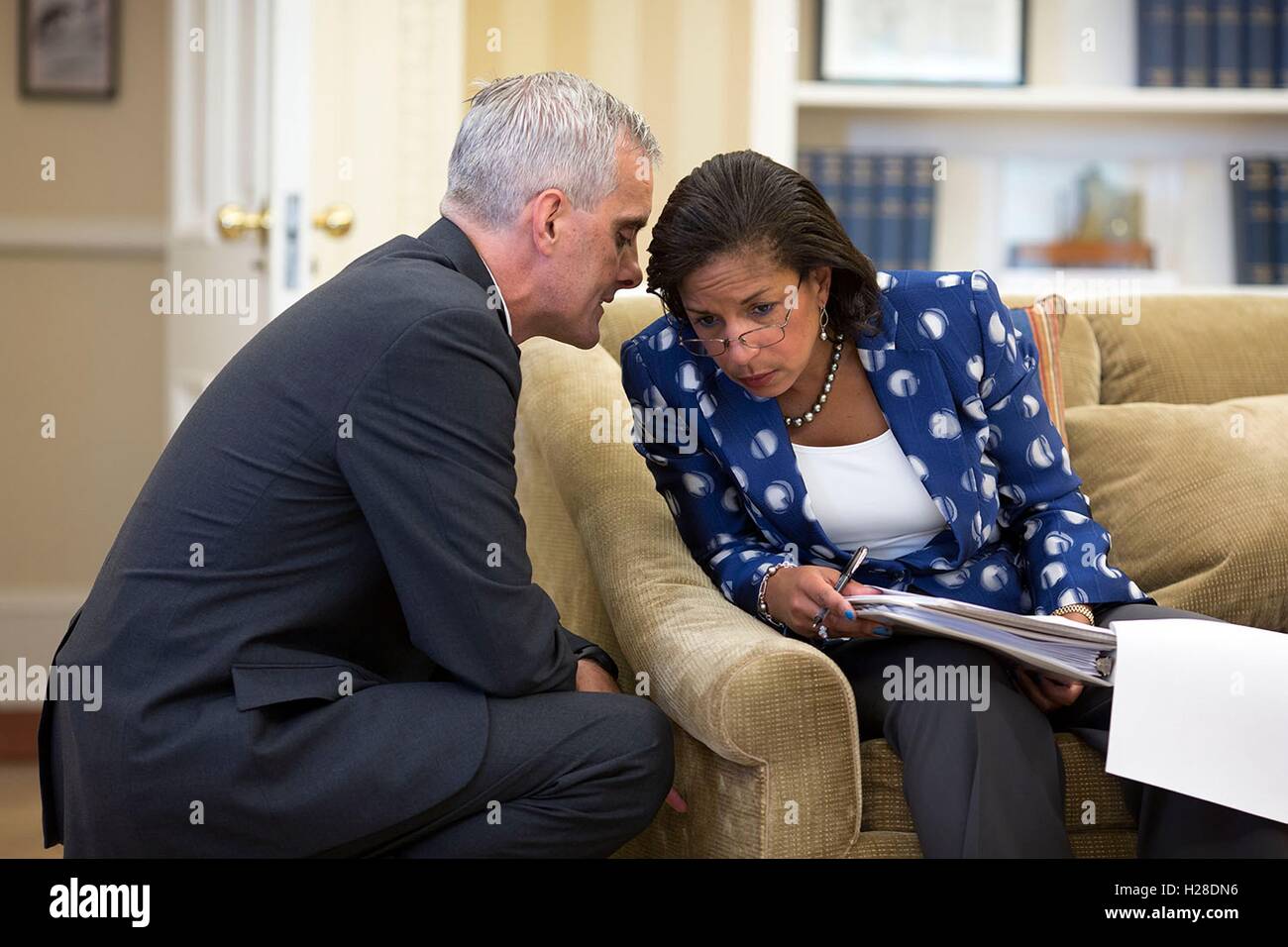 White House Chief of Staff Denis McDonough whispers to National Security Advisor Susan Rice in the Oval Office June 25, 2014 in Washington, DC. Stock Photo