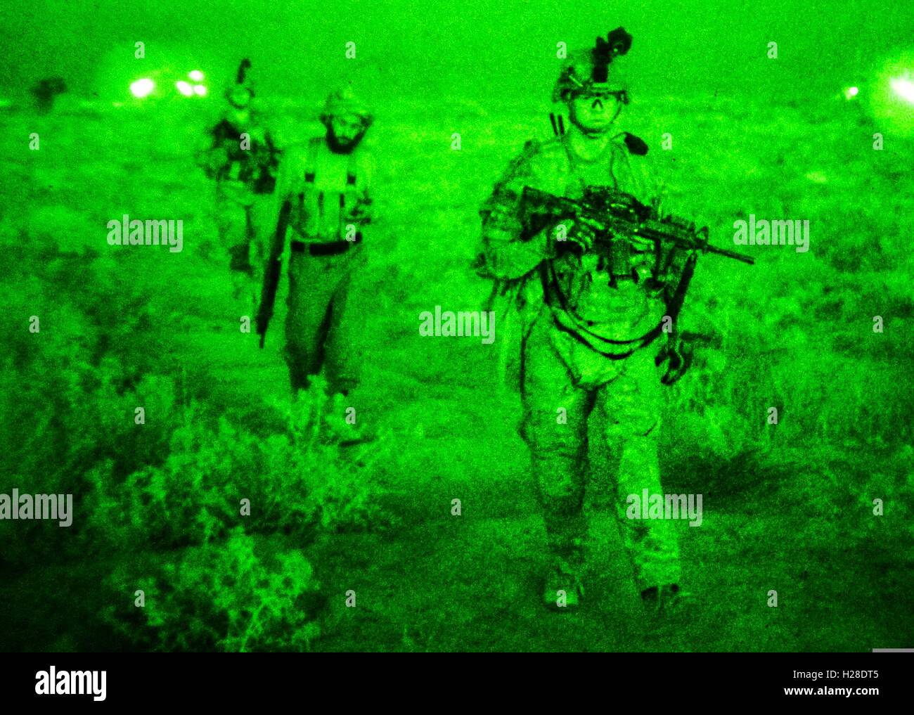 U.S. Army soldiers during a joint patrol at night with Afghan National Police officers September 15, 2014 in Tarnak Farms, Afghanistan. Stock Photo