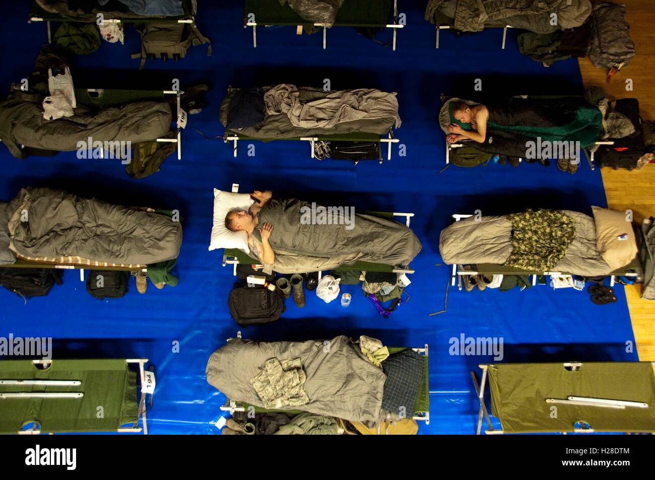 American and South Korean soldiers sleep in rows of cots during joint military exercise Key Resolve at the Osan Air Base Fitness and Sports Complex March 2, 2015 in Osan, South Korea. Stock Photo