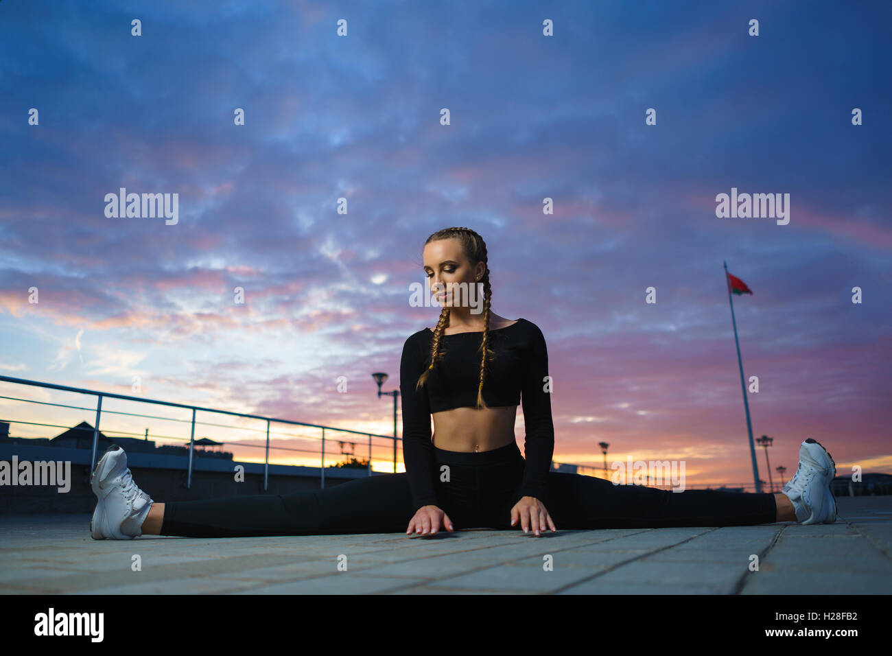 Concept: healthy lifestyle, sport. Attractive happy girl fitness trainer do outdoor workout at modern downtown urban area during Stock Photo