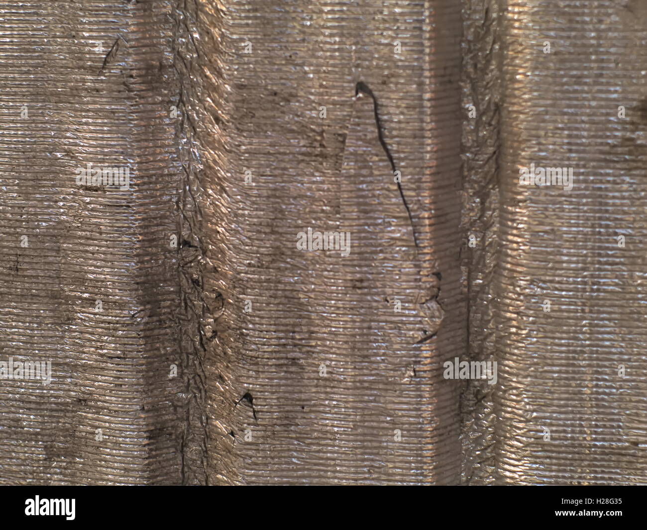 decayed corrugated tin foil sheet with scratches and dirt Stock Photo