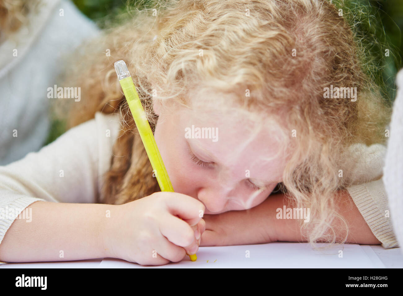 Child drawing with pen in kindergarten Stock Photo