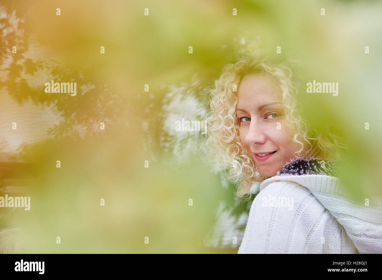 Happy blond woman in the fall at garden in the nature Stock Photo