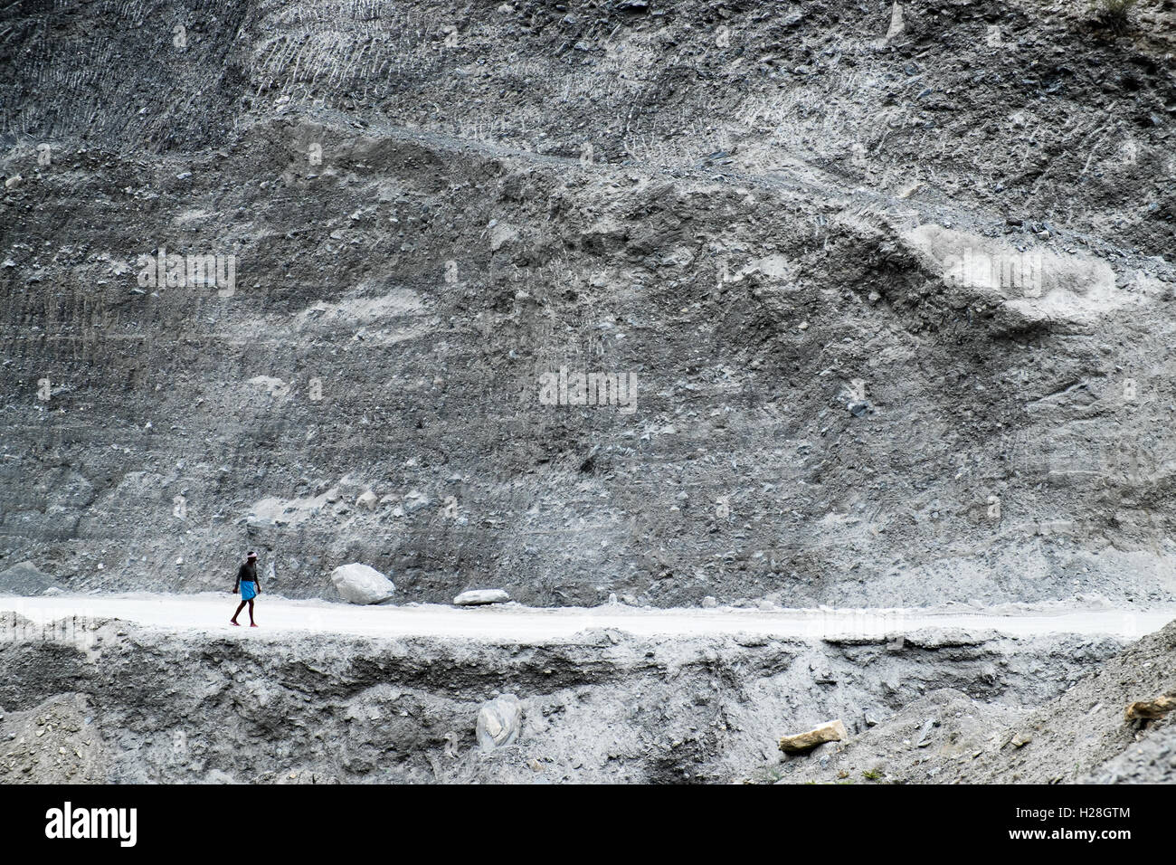 A local man walks the dusty Manali to Leh highway  Himachal Pradesh, Indian Himalayas, India Stock Photo