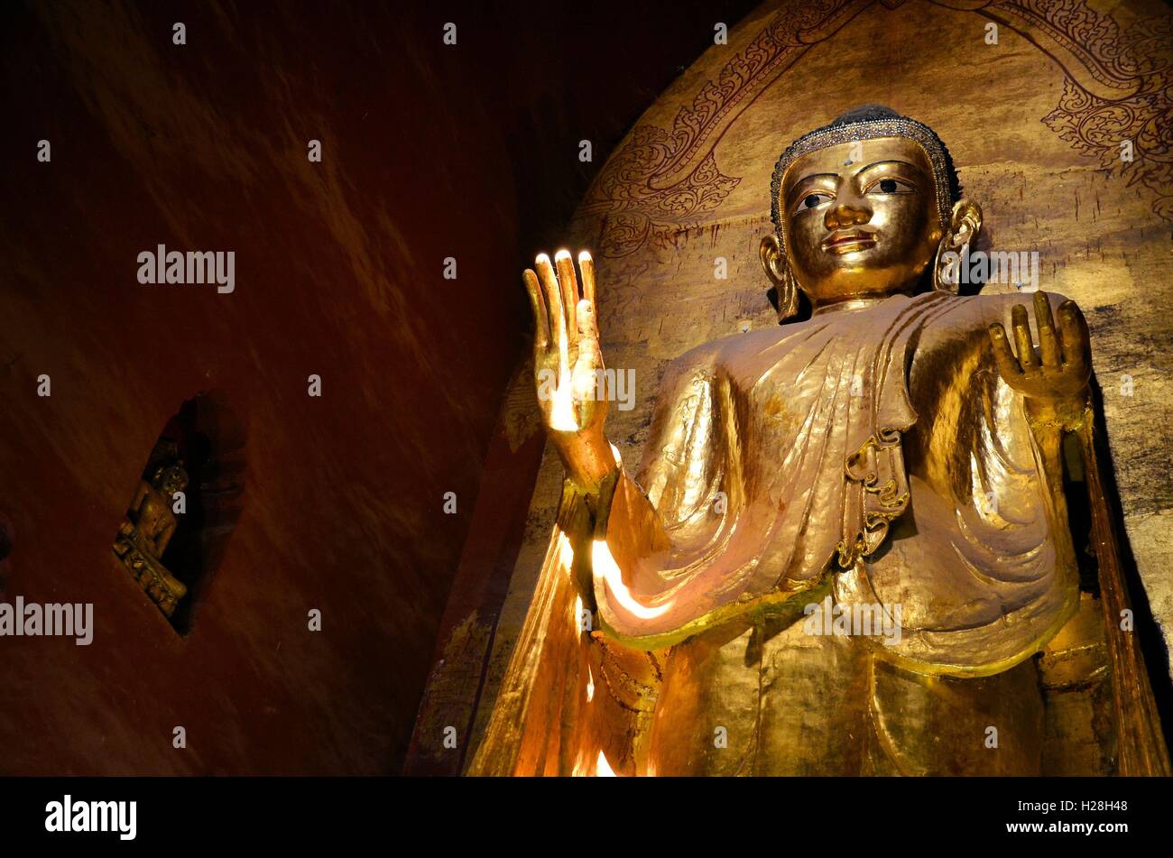 Bagan, Myanmar - March 11, 2015:  Standing Buddha Kassapa at south facing part of the Ananda temple Stock Photo