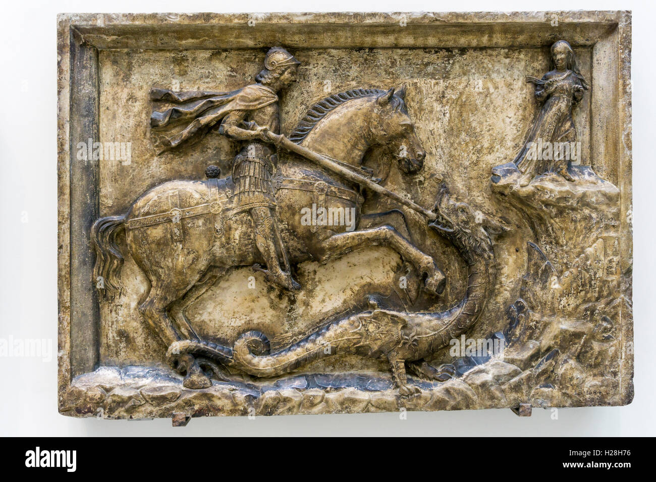 16th century stone relief of St George fighting dragon.  Originally from a house in Venice, now in the Victoria & Albert Museum. Stock Photo