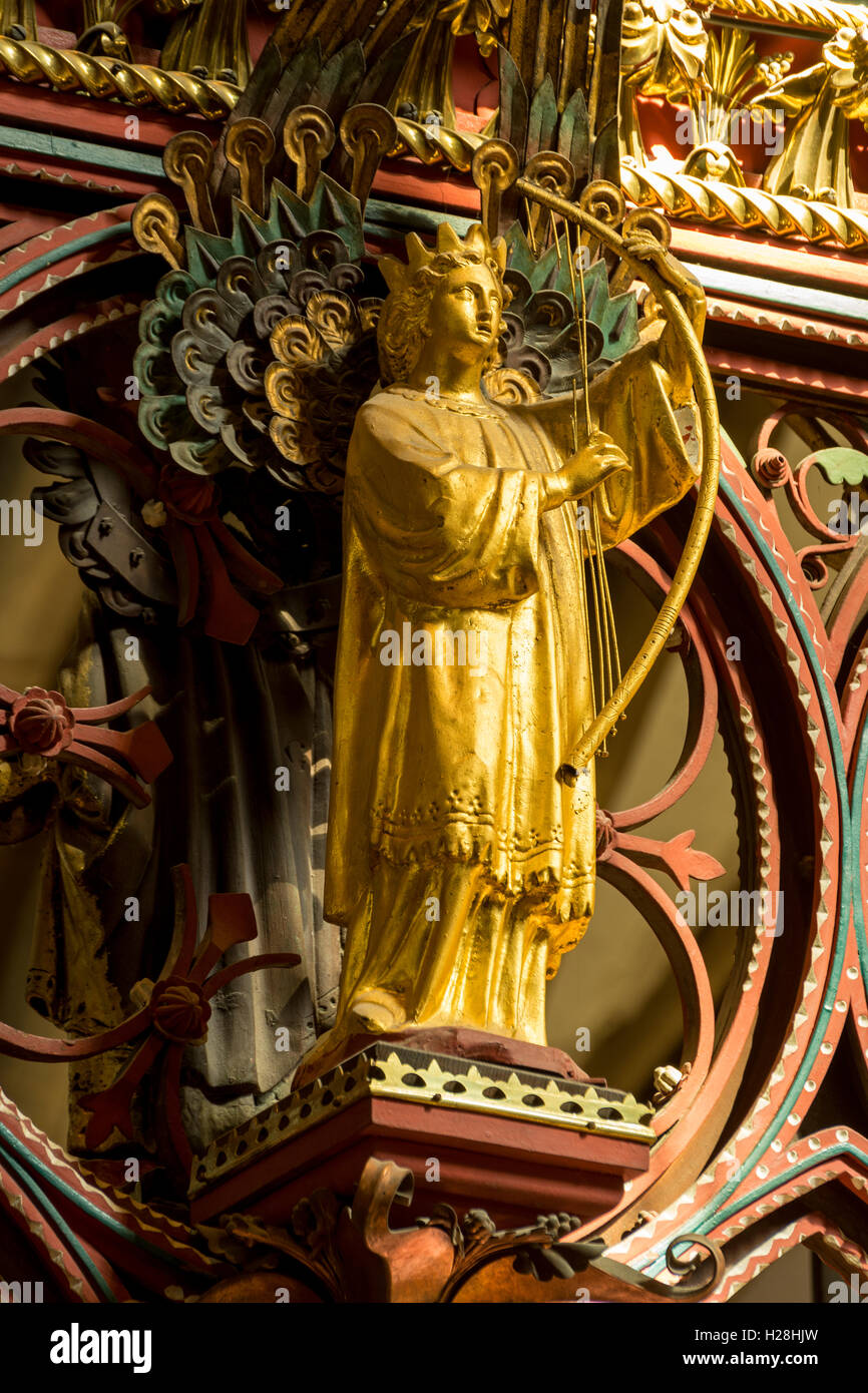 Angel playing a musical instrument. On the Skidmore screen, Lichfield