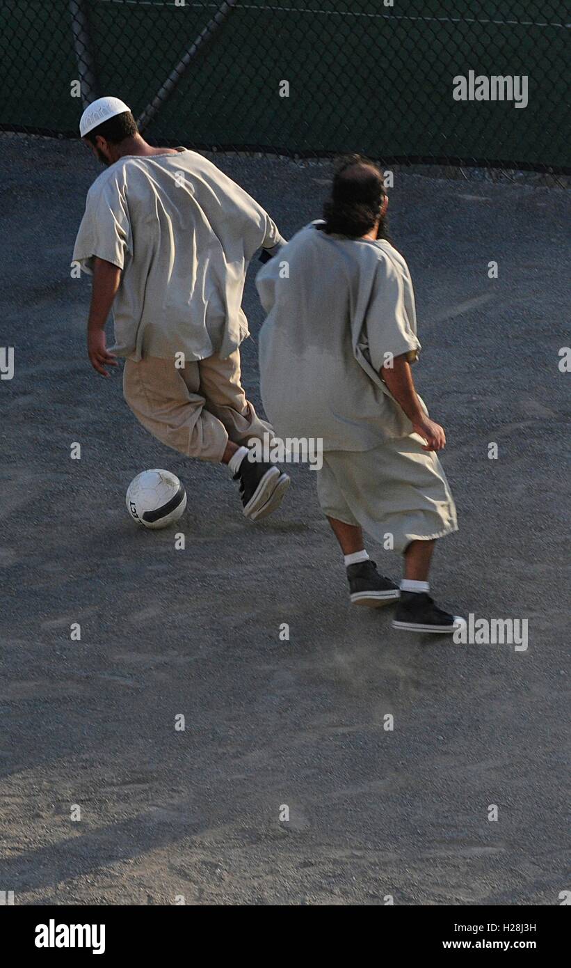 Detainees from the war on terror play soccer in the recreation area of Camp Six at Joint Task Force Guantanamo March 1, 2011 in Guantanamo Bay, Cuba. Stock Photo