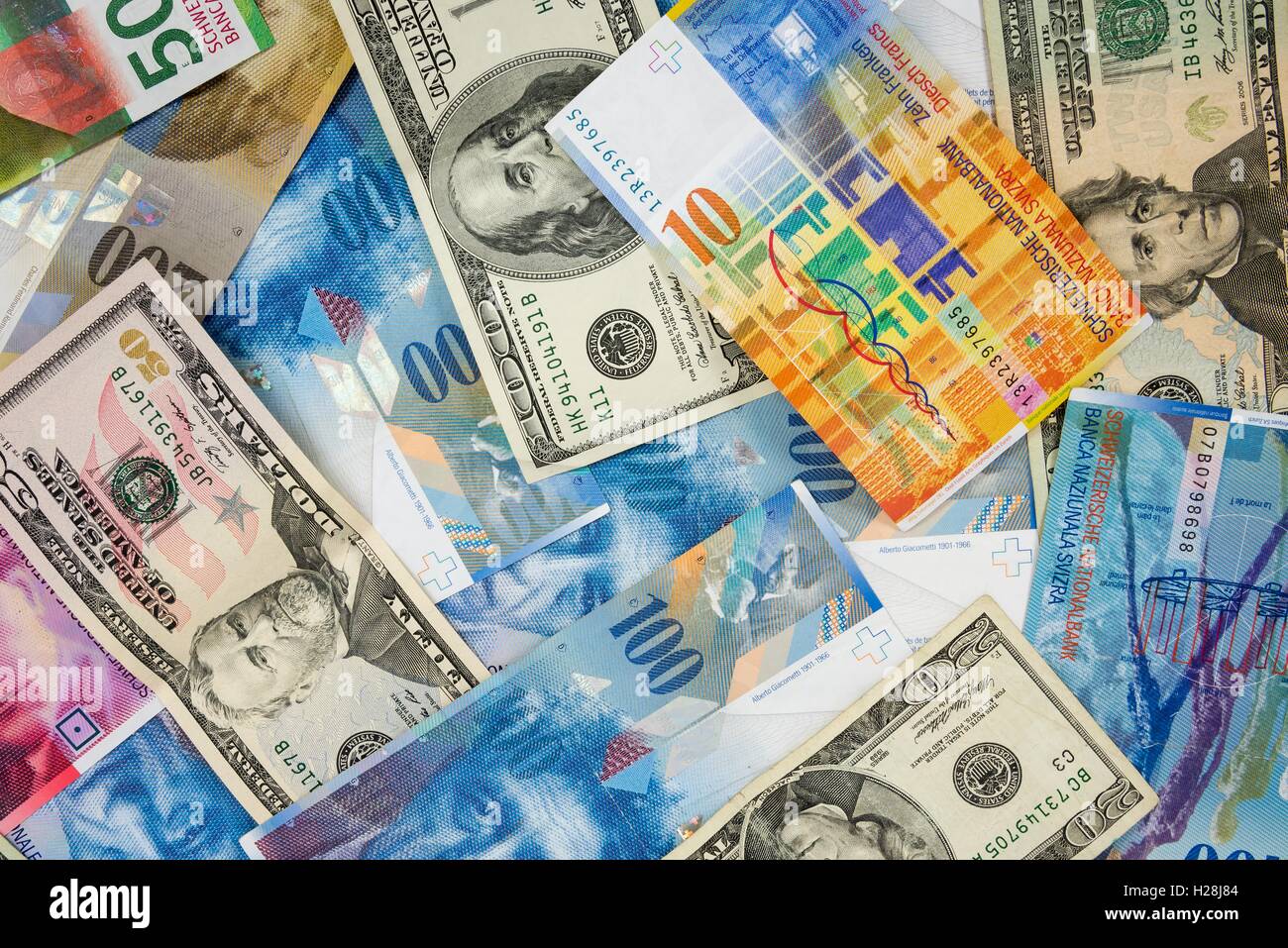Background made of dollar and swiss franc banknotes Stock Photo