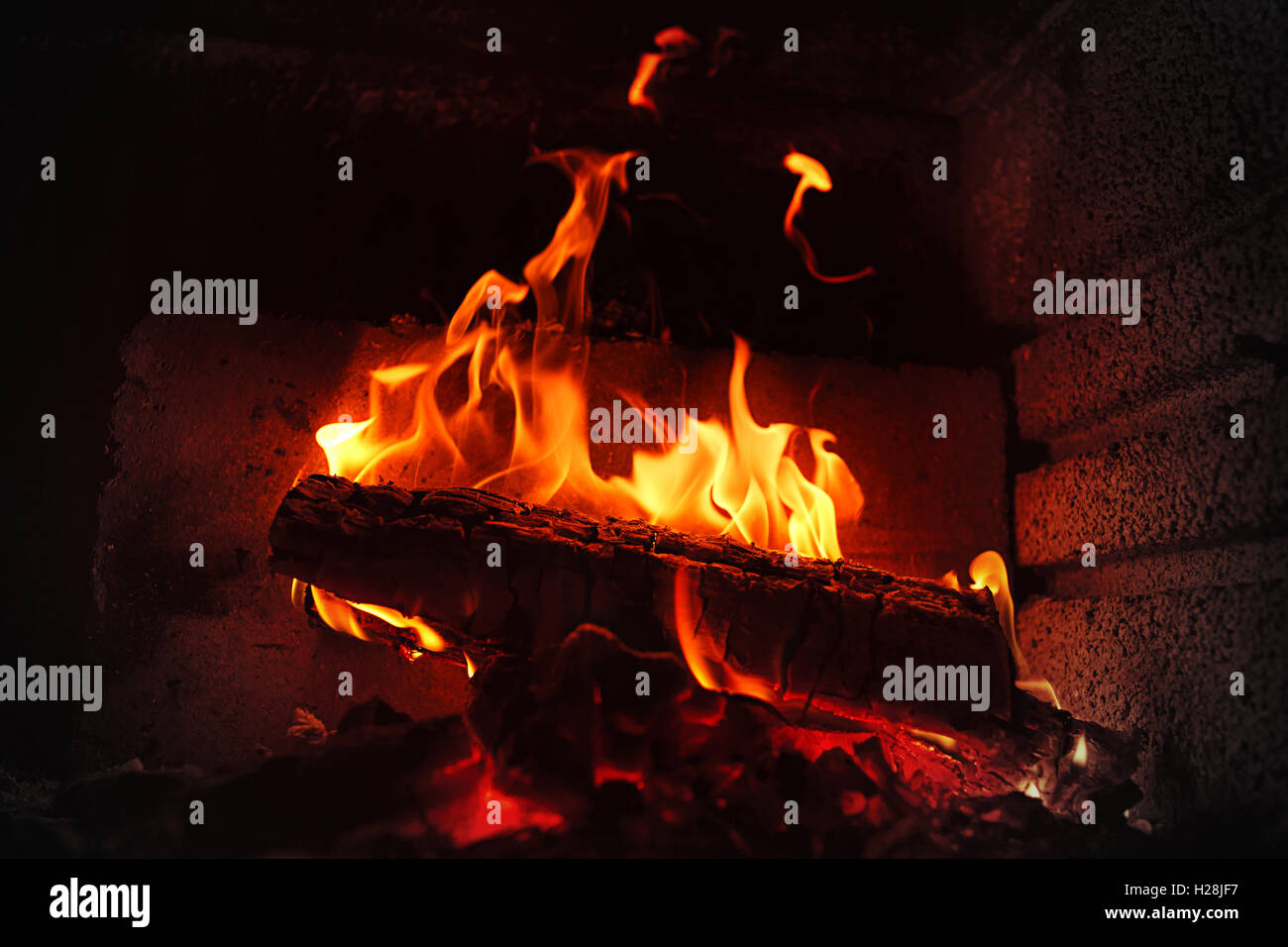 Burning wood in brick fireplace Stock Photo Alamy