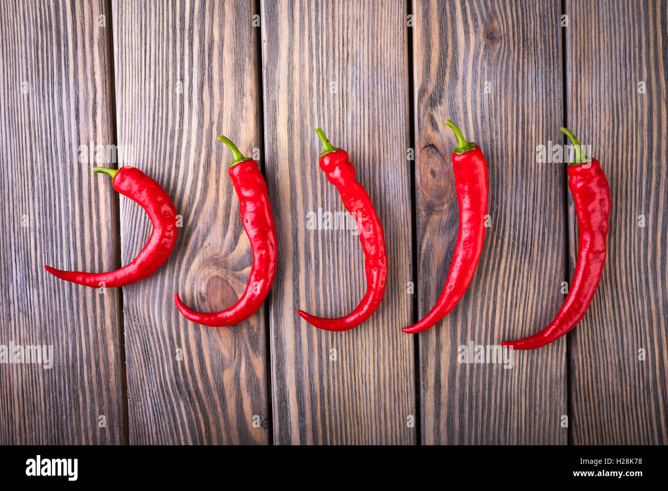 Red hot chili peppers on wood background Stock Photo - Alamy