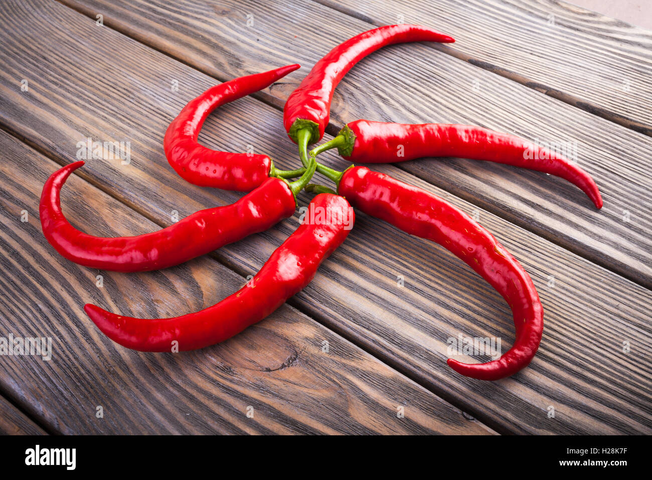 Red hot chili peppers on wood background Stock Photo - Alamy