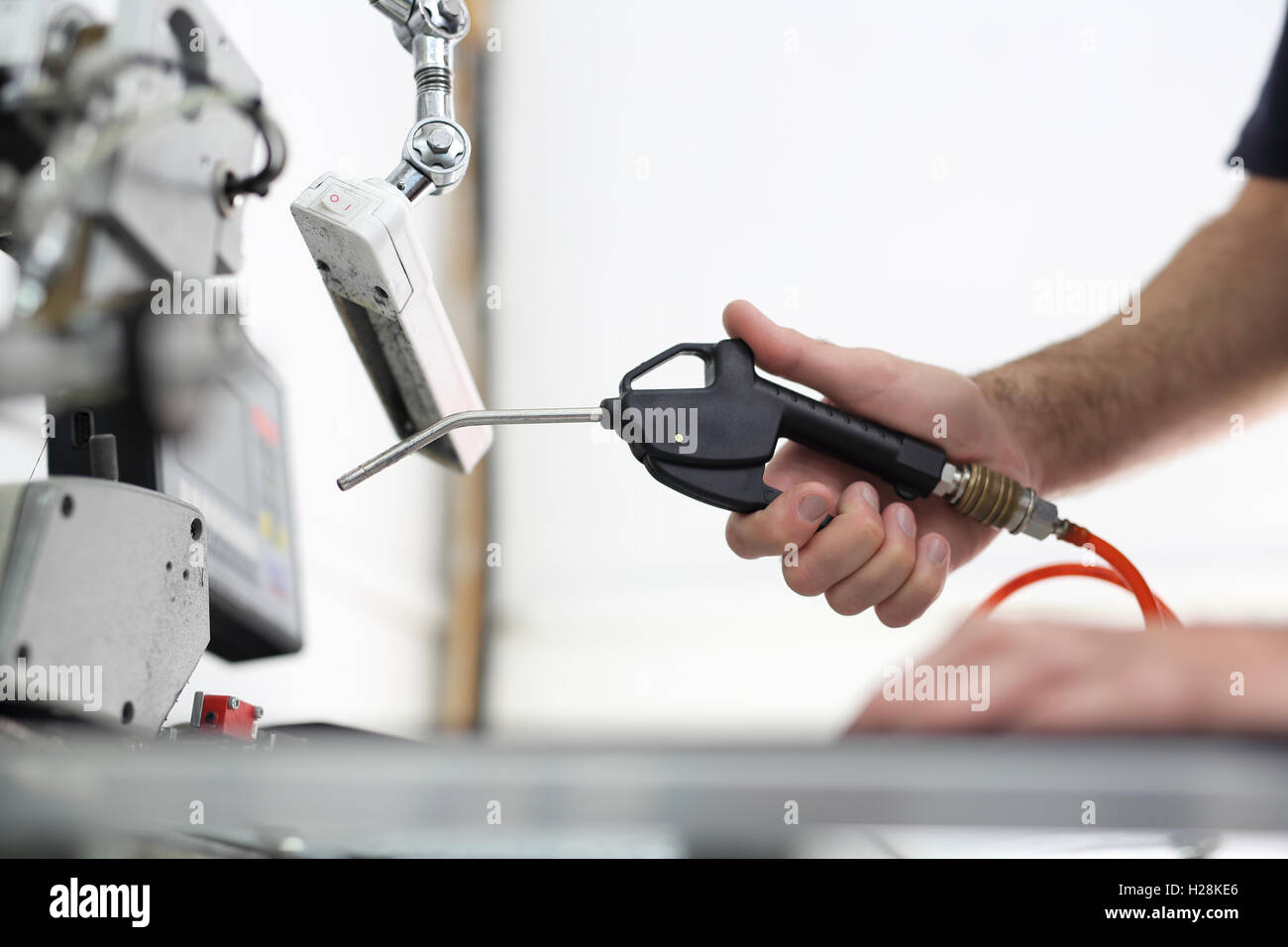 The production plant, cleaning the sewing machine worker cleans the