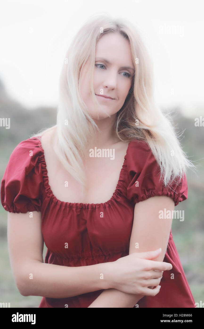 portrait of a blonde woman in a red dress Stock Photo