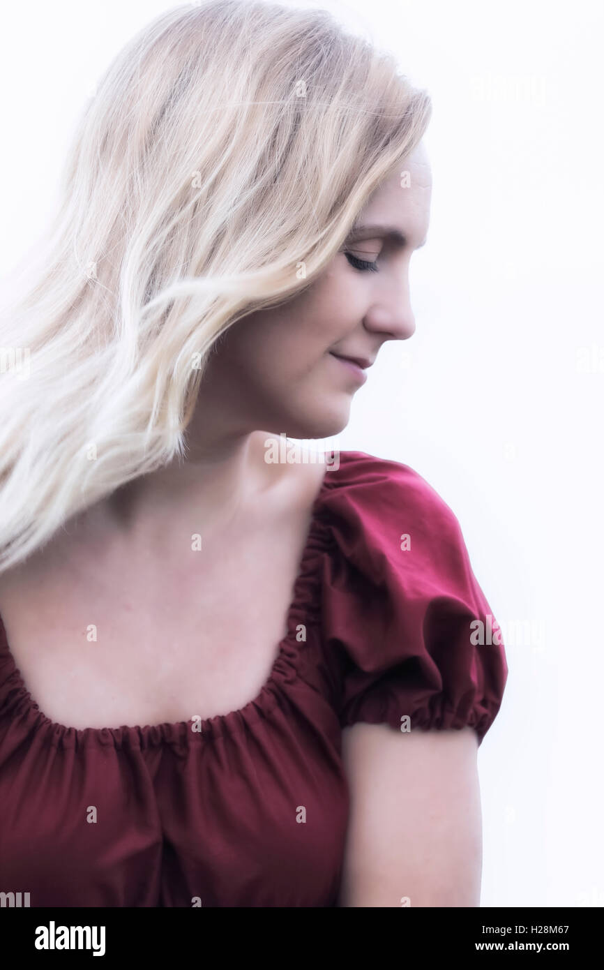 portrait of a blonde woman in a red dress Stock Photo