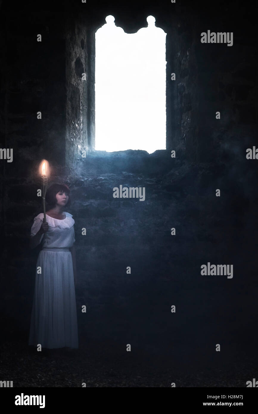 a ghostly woman in a white dress is standing in an old church with a flare Stock Photo