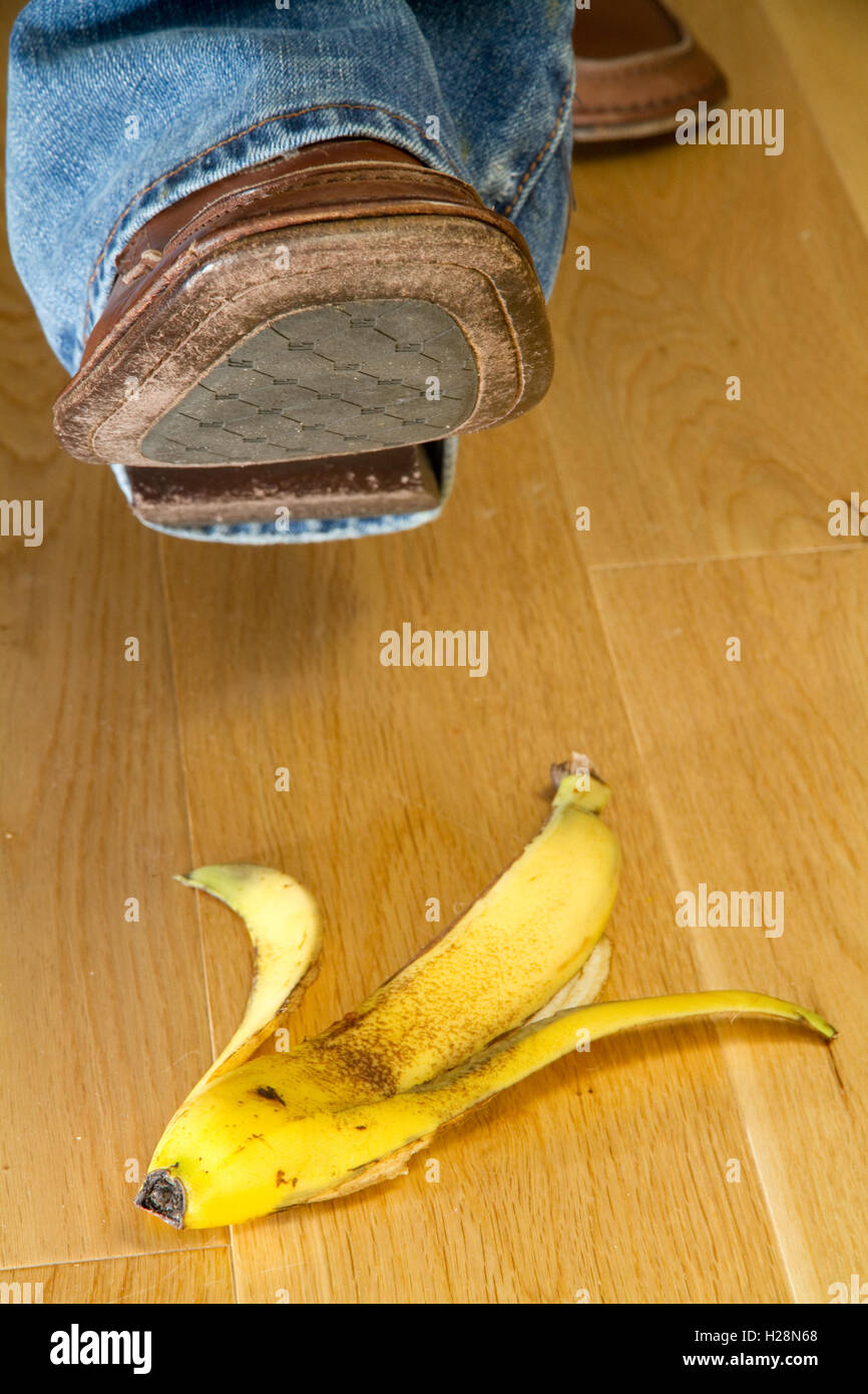 Close up of a foot about to tread on a banana skin Stock Photo - Alamy