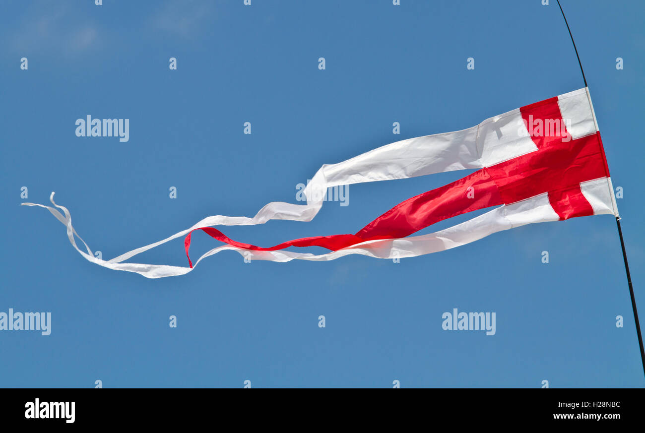 The English flag, the red cross of St George, flying as a pennant against a blue sky on a sunny day Stock Photo