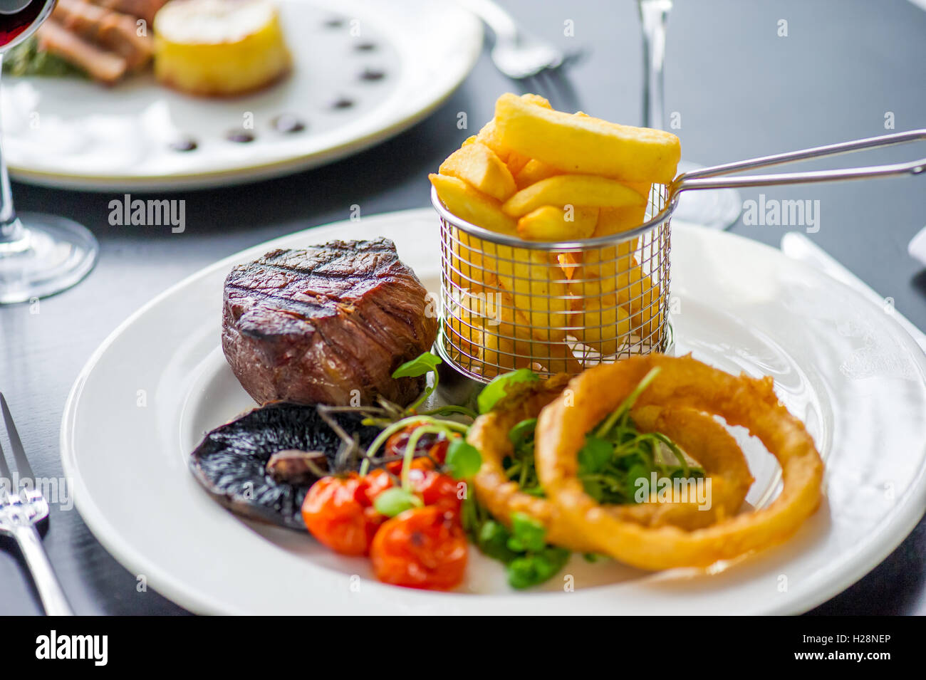 A fillet steak with onion rings and chips Stock Photo Alamy