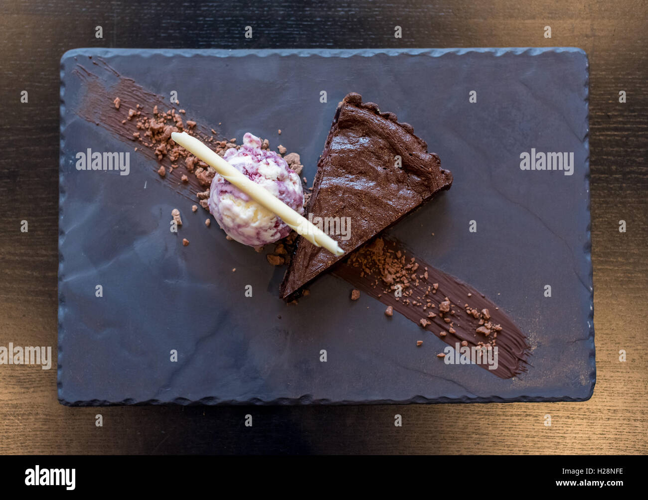 Chocolate cake and ice cream on a slate plate Stock Photo
