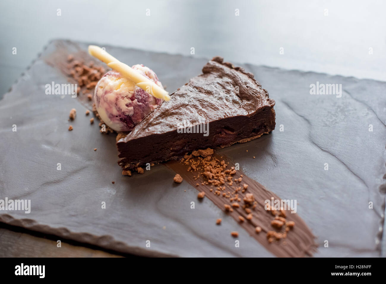Chocolate cake and ice cream on a slate plate Stock Photo