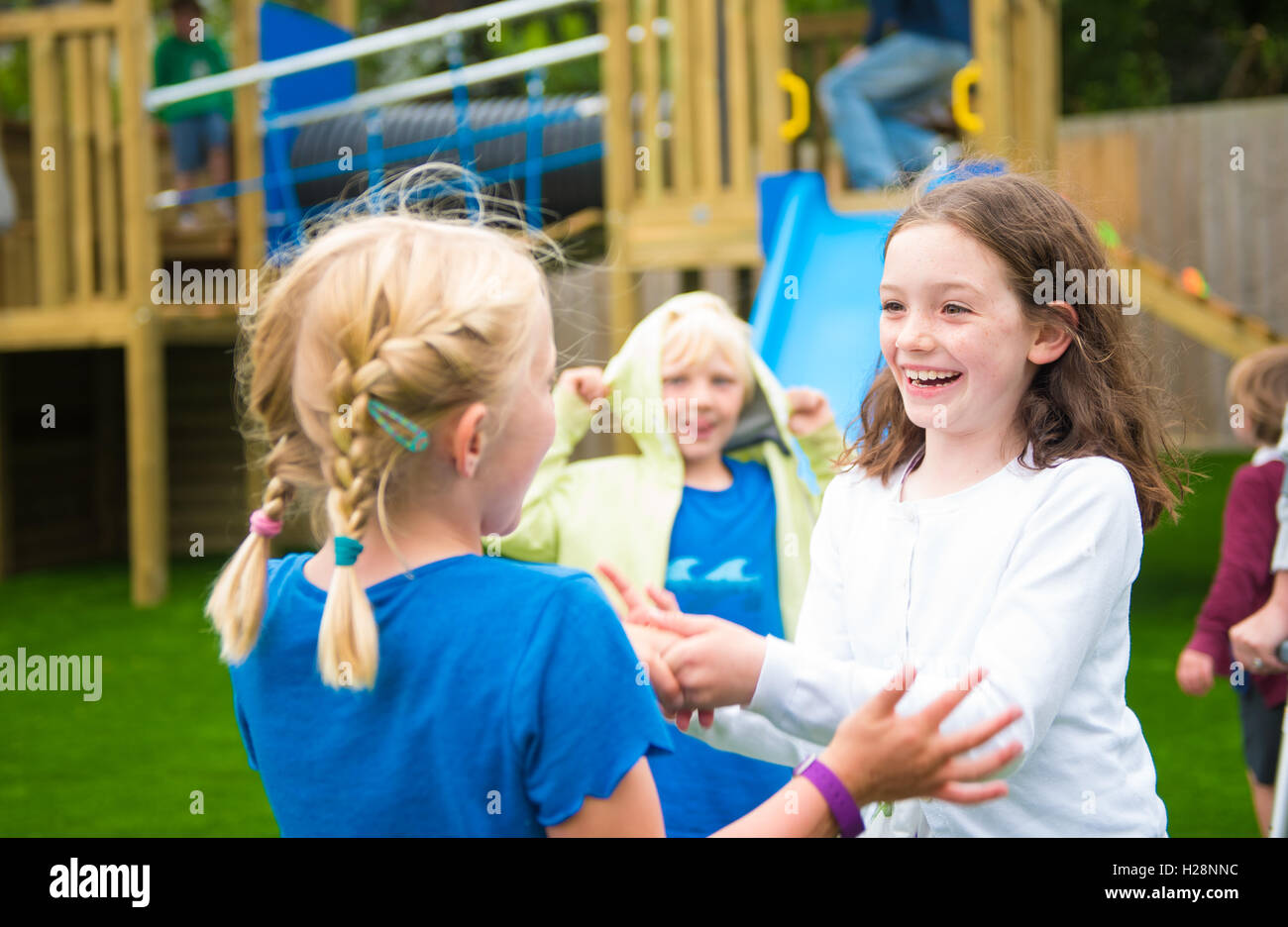 a group of young girls playing in a park Stock Photo