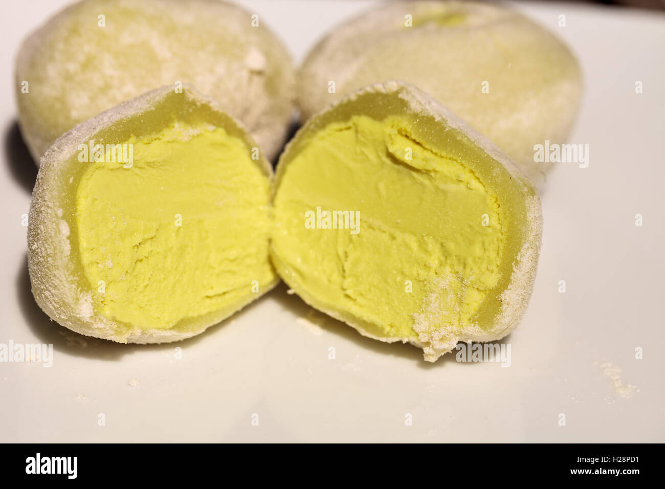 Green tea mochi ice cream bonbon desert on a white plate Stock Photo