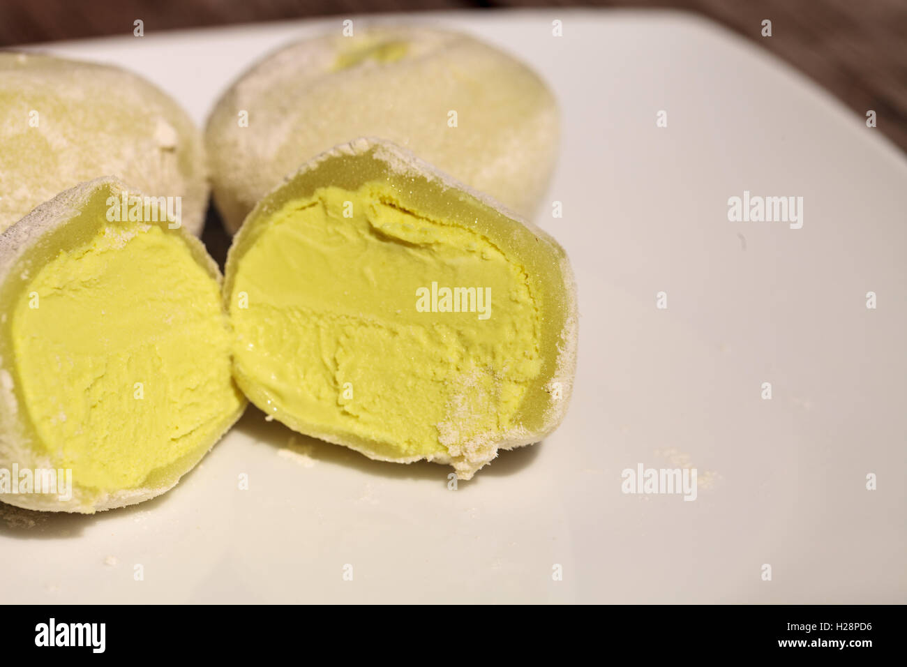 Green tea mochi ice cream bonbon desert on a white plate Stock Photo