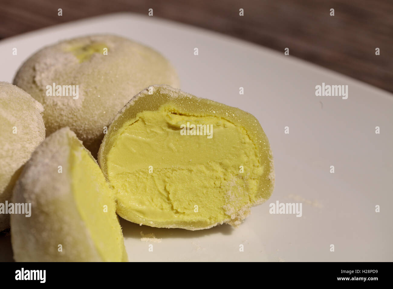 Green tea mochi ice cream bonbon desert on a white plate Stock Photo