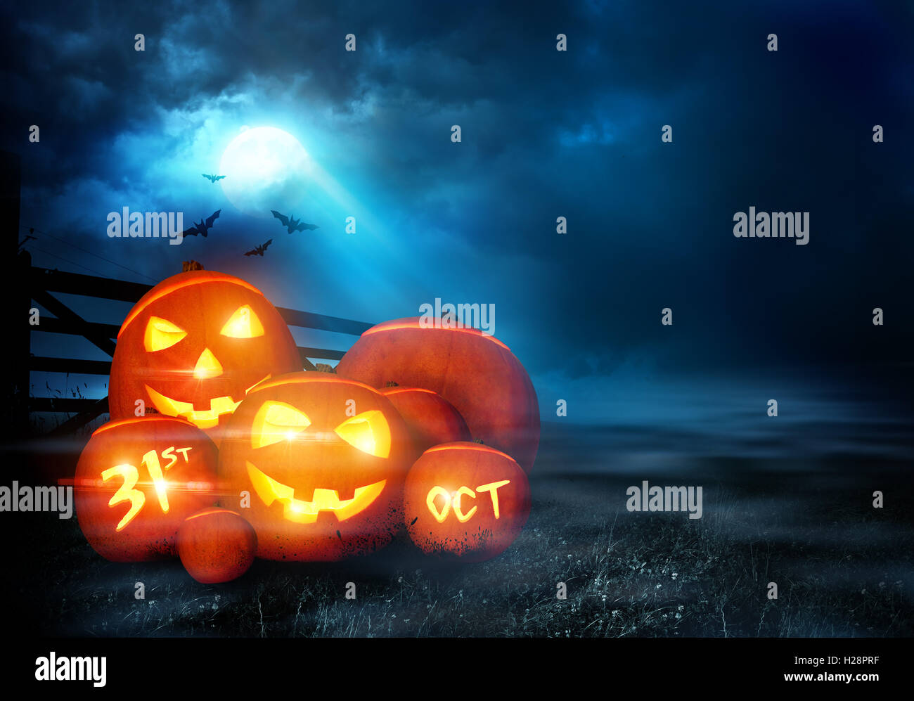 A group of halloween Jack O Lantern pumpkins with smiling faces glowing ...