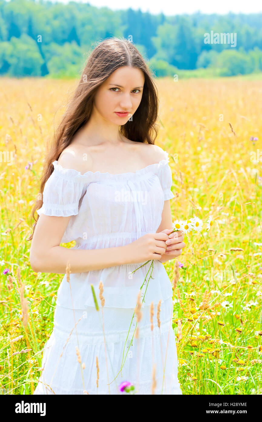 young beautiful girl in a white sundress in the field Stock Photo - Alamy