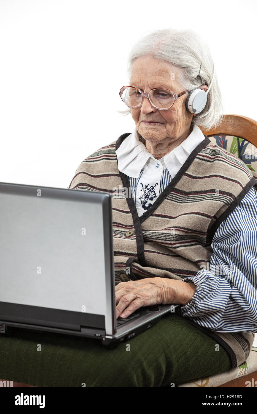Senior woman using laptop computer over white Stock Photo - Alamy