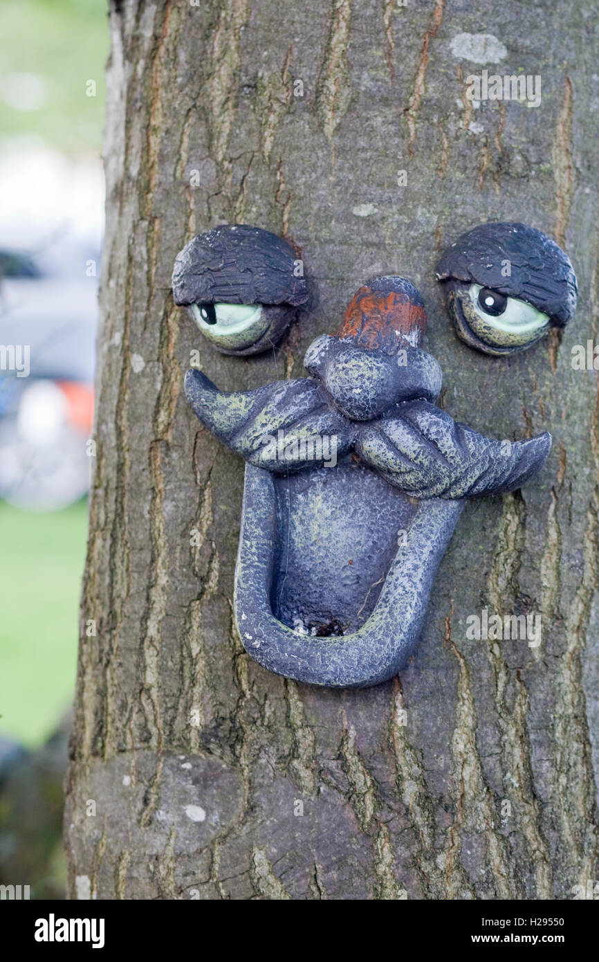 Face Made From Plastic Stuck To A Tree For Decoration Stock Photo