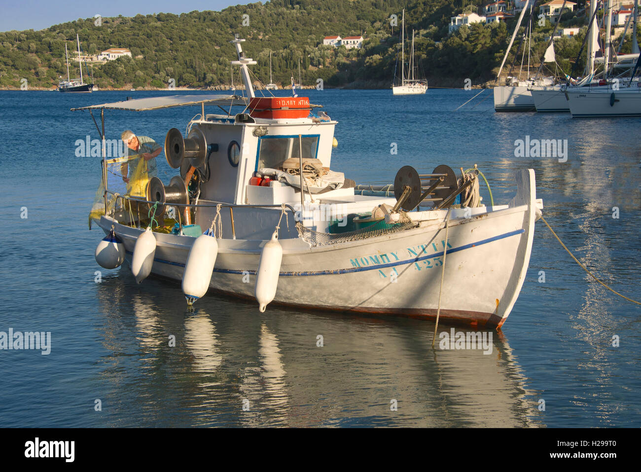 Fisherman sorting nets on boat Kioni Ithaka Island Ionian Islands Greece Stock Photo