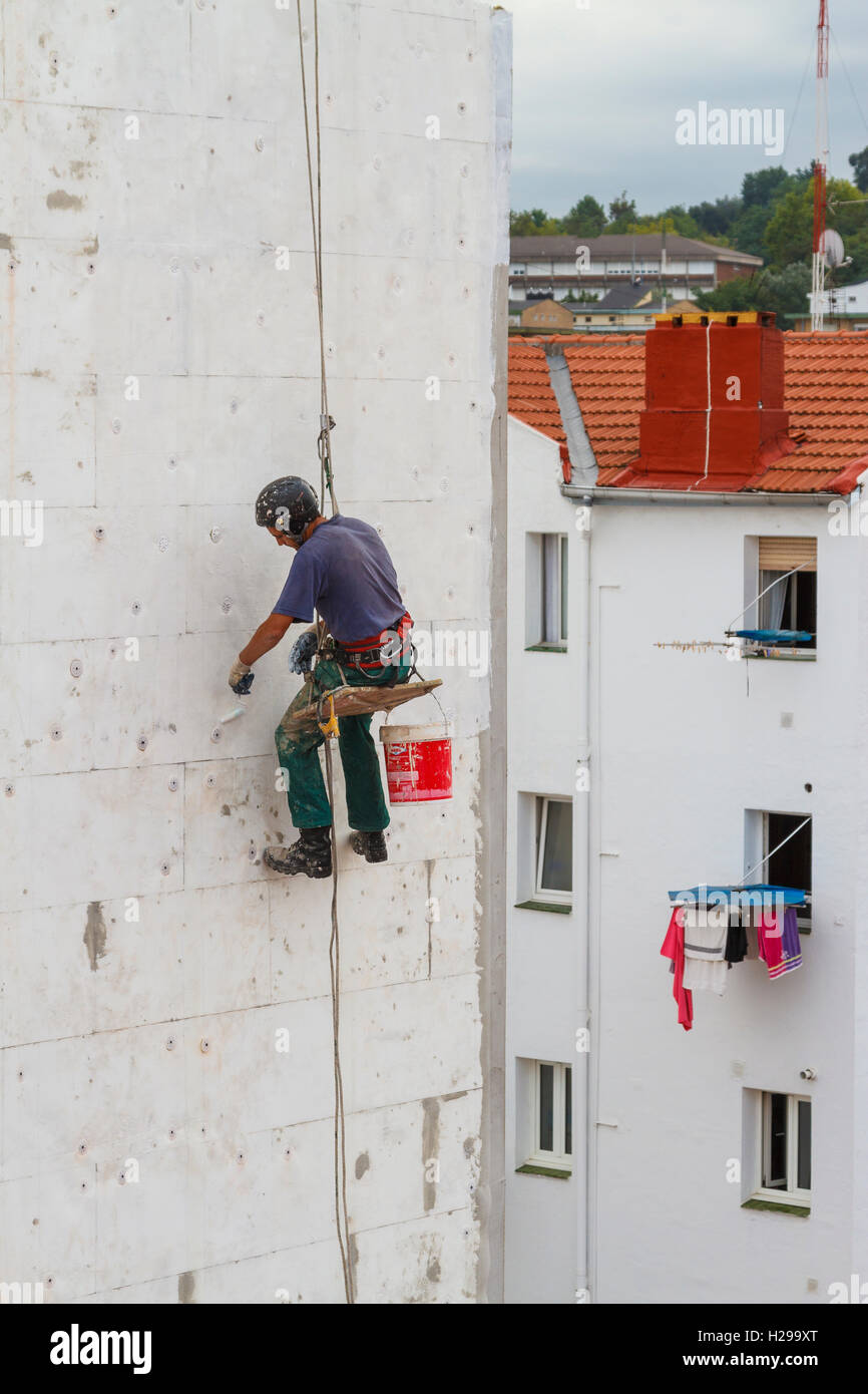 Skilled worker working in a house wall. Stock Photo