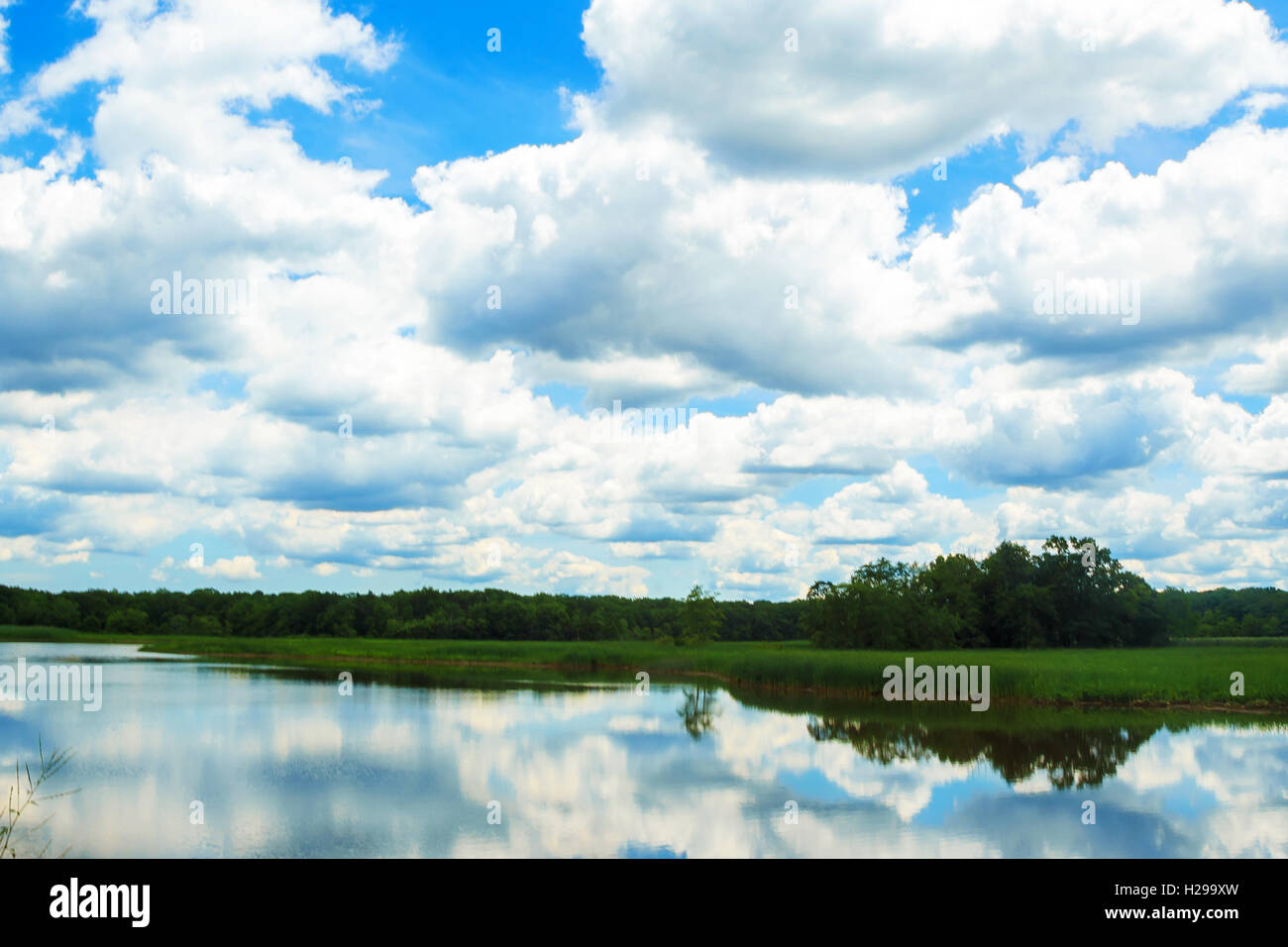 reflections of clouds and blue sky Stock Photo - Alamy