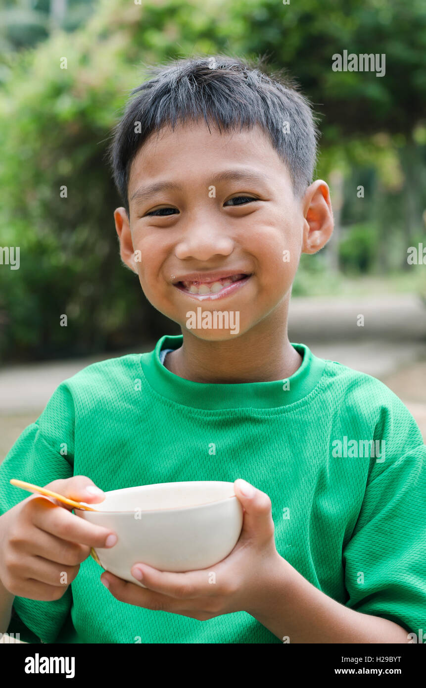 Asian Child Eating The Breakfast. Stock Photo