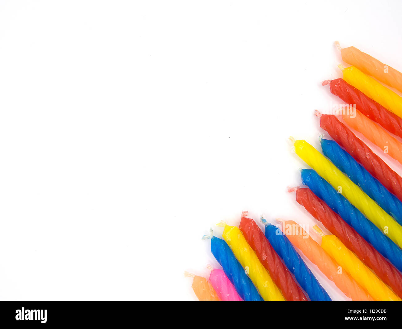 multiple color birthday candles on the white background located on the